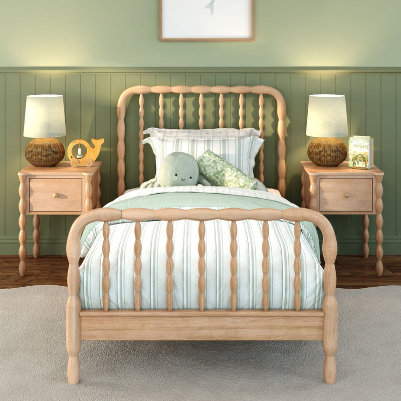 Children's bedroom with light wooden spindle bed, green paneled accent wall, striped mint bedding, matching nightstands with woven lamps and plush octopus toy