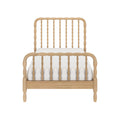 Light natural wood spindle bed frame with turned spindle headboard and footboard and white mattress, farmhouse-style bedroom furniture