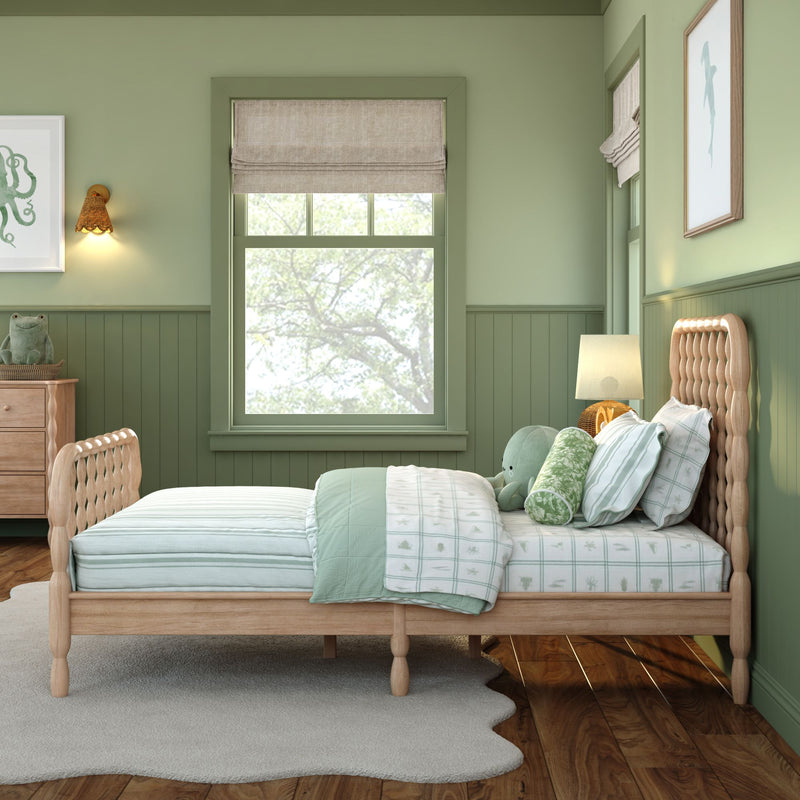 Mint green children's bedroom with wooden spindle bed, striped and patterned bedding, plush toys, roman shade window and wooden dresser
