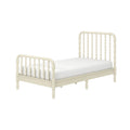 Cream ivory wooden twin bed with spindle headboard and footboard and white mattress, farmhouse-style bedroom