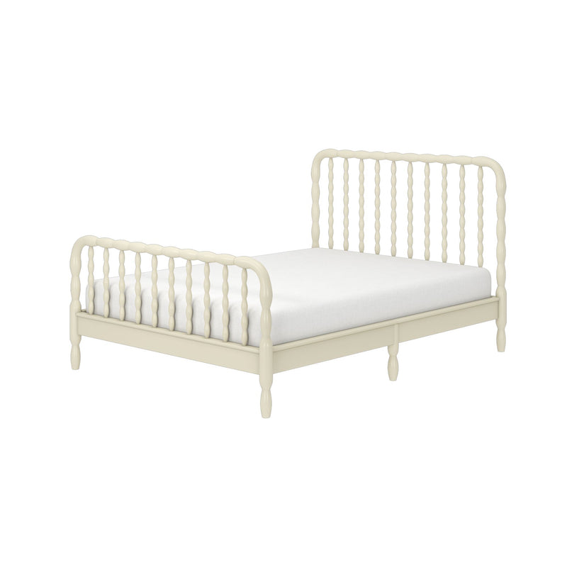 Ivory wooden spindle bed frame with turned headboard and footboard and white mattress, vintage-inspired bedroom furniture on white background