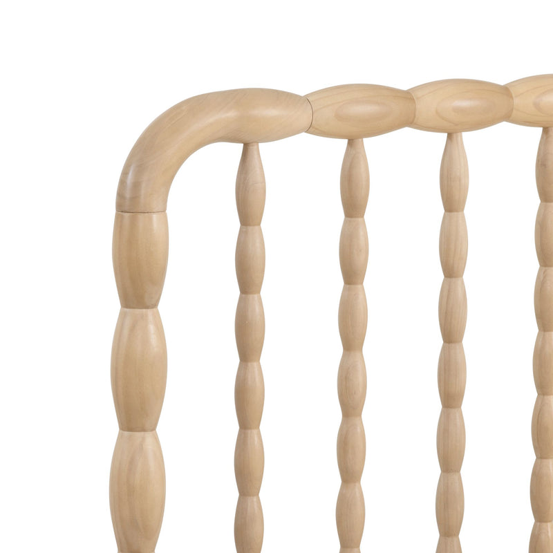 Close-up of light natural wood turned spindle headboard with smooth rounded spindles