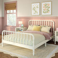 Cozy pastel girls bedroom with white spindle bed, yellow gingham bedding, pink wainscoting, floral art and jute rug