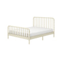 Cream wooden spindle bed frame with turned-spindle headboard and footboard and white mattress, farmhouse-style bedroom bed