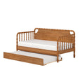 Solid wood spindle daybed in natural oak finish with white mattress and pull-out trundle bed