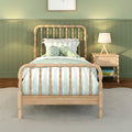 Kids bedroom with natural wood spindle twin bed, sage green striped bedding, plush octopus toy and wooden nightstand with lamp against green wainscoting