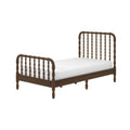Dark walnut wooden spindle twin bed frame with turned spindle headboard and footboard and white mattress, isolated on white background