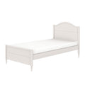 White wooden twin bed frame with arched headboard, scalloped footboard and turned legs, mattress included — farmhouse-style single bed for kids or guest bedroom