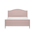 Pink painted wooden bed frame with arched headboard, scalloped footboard and turned legs on white background