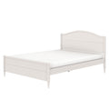 White wooden bed frame product photo on white background with mattress, curved paneled headboard, scalloped footboard and turned legs — classic modern farmhouse bedroom furniture
