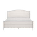 White wooden bed frame with arched headboard and scalloped footboard, farmhouse cottage-style platform bed with turned legs and smooth painted finish