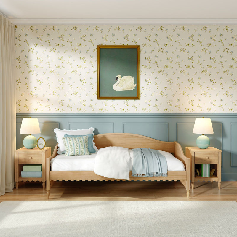 Cozy pastel bedroom with wooden daybed, floral wallpaper, framed swan painting, bedside nightstands and lamps.