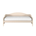 Cream wooden daybed with curved headboard, scalloped apron trim and white mattress — farmhouse-style twin bedroom bed