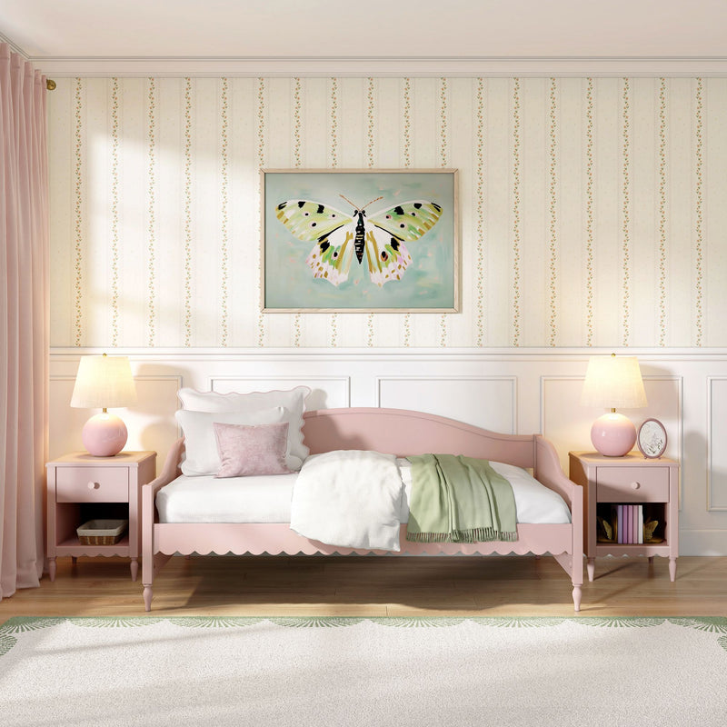 Pastel pink children's bedroom with scalloped twin bed, butterfly wall art, matching pink nightstands and lamps, floral striped wallpaper