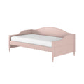 Blush pink wooden twin daybed with scalloped trim, turned legs and white mattress for children's bedroom