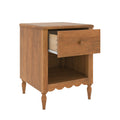 Wooden bedside table with single drawer and open shelf, turned legs and scalloped apron in warm oak finish