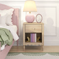 Wooden bedside nightstand with pink ceramic table lamp, oval floral frame, pastel pink bedframe, white bedding and green knit throw in a modern pastel bedroom