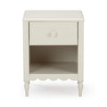 White painted wooden bedside nightstand with one drawer and open shelf, scalloped apron and turned legs, farmhouse style