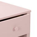 Close-up of pink wooden dresser drawer with round knob and matte finish, modern nursery storage chest