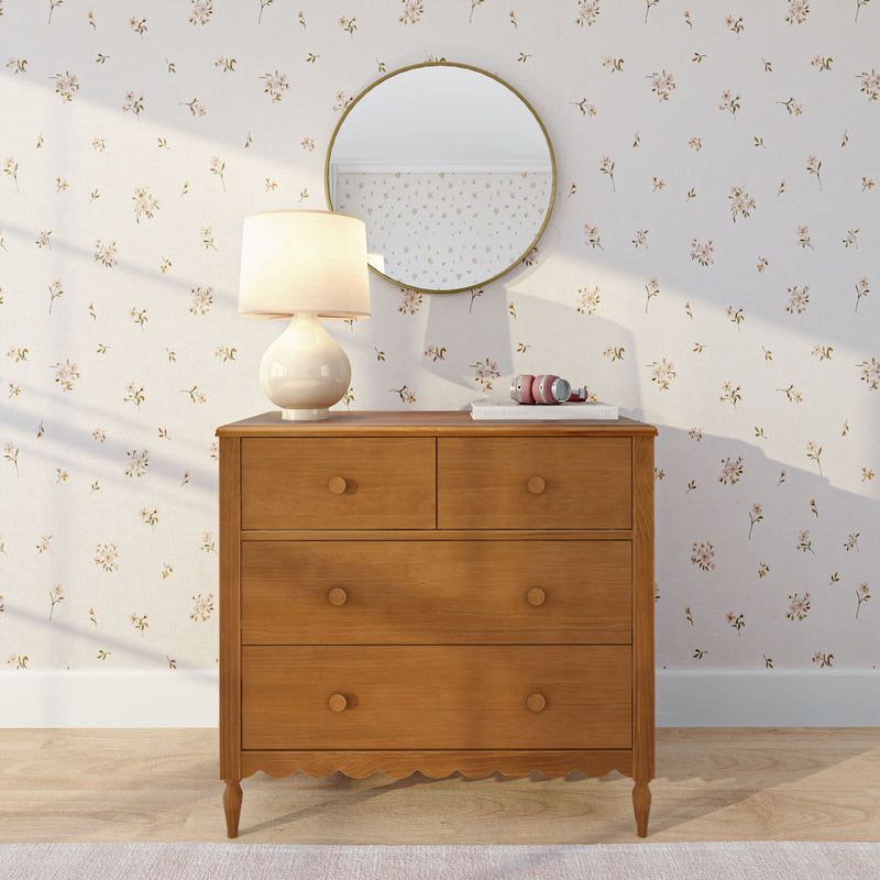 Wooden mid-century dresser with ceramic table lamp, round mirror and floral wallpaper, bedroom decor