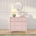Pastel pink dresser with green ceramic table lamp, round gold mirror and floral striped wallpaper in a shabby-chic nursery bedroom decor scene