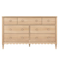 Light natural wood 7-drawer farmhouse dresser with round knobs, scalloped apron and turned legs for bedroom storage