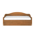 Rustic solid-wood daybed with curved carved headboard and white mattress, farmhouse-style wooden bed frame on white background