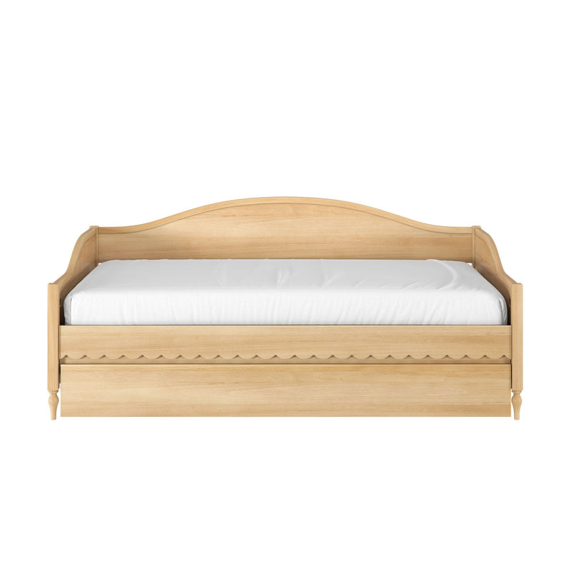 Light oak wooden twin daybed with curved headboard, scalloped storage drawer front and white mattress