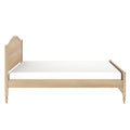 Light oak wooden bed frame with arched headboard, turned legs and white mattress — minimalist Scandinavian-style single/twin bed