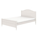 White wooden twin bed frame with curved headboard, scalloped footboard apron and mattress — classic farmhouse cottage bedroom furniture