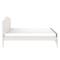 White wooden twin bed frame with curved headboard, turned legs and mattress — farmhouse-style platform bed product shot on white background