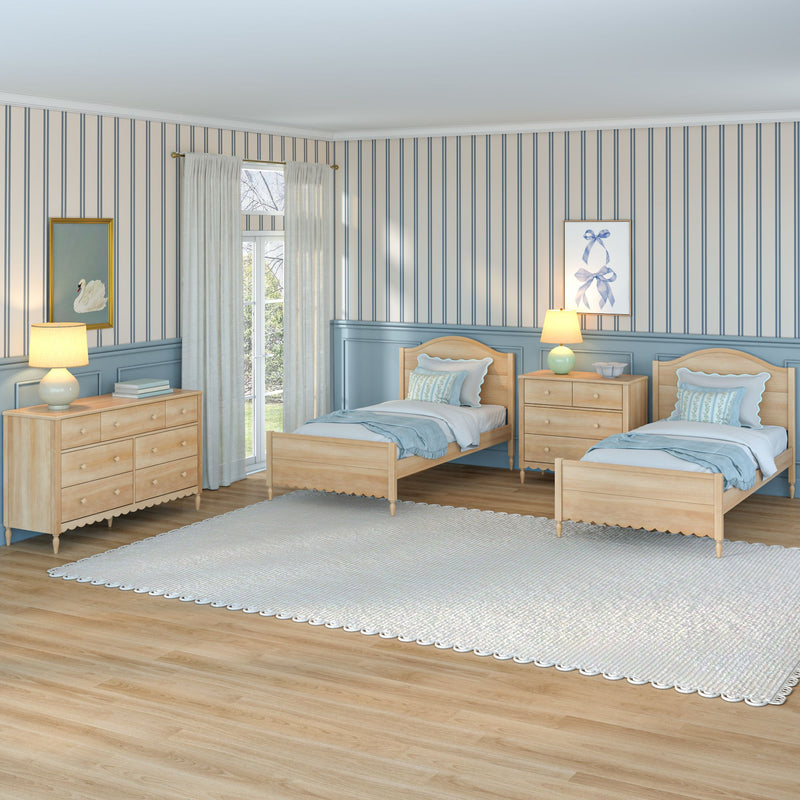 Twin bedroom with blue striped wallpaper, light wood twin beds and dressers, bedside lamps, sheer curtains, hardwood floor rug
