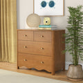 Mid-century wooden dresser with round paper lamp, yellow instant camera on stacked books, potted bamboo and mustard curtains