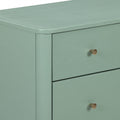 Sage green modern dresser close-up showing rounded top corner, matte painted finish, drawer fronts and brass cone knob