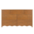 7-drawer solid wood dresser in warm honey oak finish with round brass knobs and scalloped apron — classic farmhouse bedroom storage chest