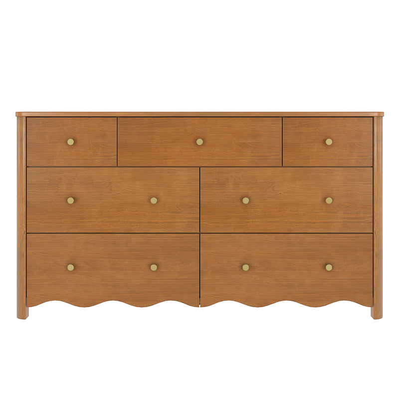 7-drawer solid wood dresser in warm honey oak finish with round brass knobs and scalloped apron — classic farmhouse bedroom storage chest