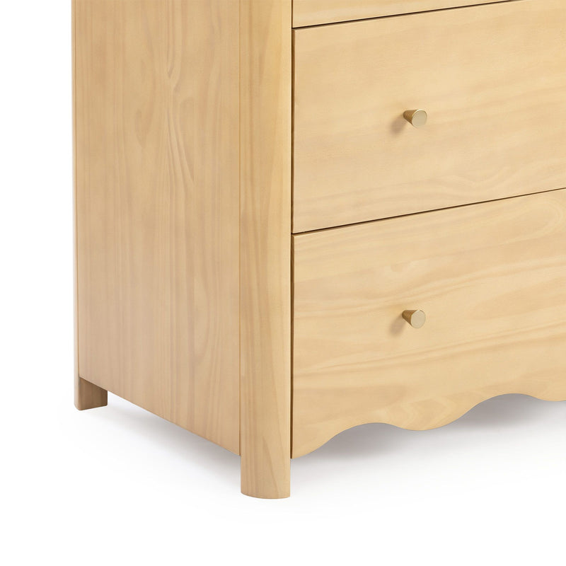 Light wood three-drawer dresser nightstand with round brass knobs and scalloped base, modern bedroom storage