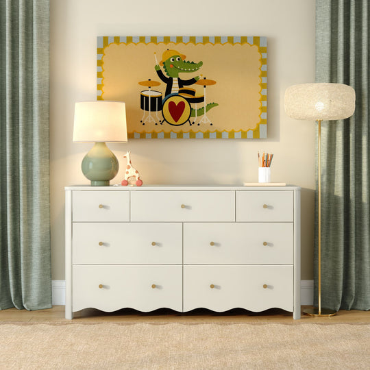 White six-drawer dresser in a children's nursery with whimsical alligator drummer wall art, ceramic table lamp, floor lamp, green curtains, and toy decor