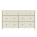 White wooden 7-drawer dresser with scalloped bottom edge and brass knobs, nursery or kids' bedroom storage dresser in modern farmhouse style