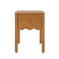 Light brown wooden bedside nightstand with single drawer, round brass knob and scalloped apron — compact mid-century style end table for bedroom storage