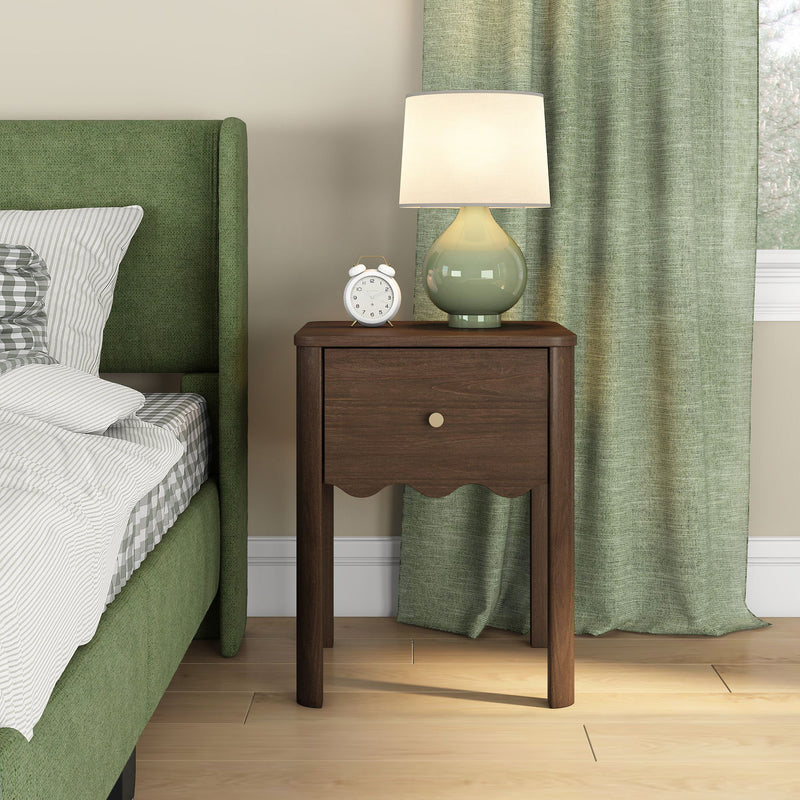 Walnut nightstand bedside table beside green upholstered bed with ceramic lamp, white alarm clock and matching green curtains — modern bedroom decor