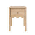 Natural light wood nightstand bedside table with single drawer, scalloped apron and round brass knob on four legs — compact rustic modern design