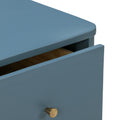Matte blue wooden nightstand drawer with brass cone knob, close-up of slightly open modern dresser detail