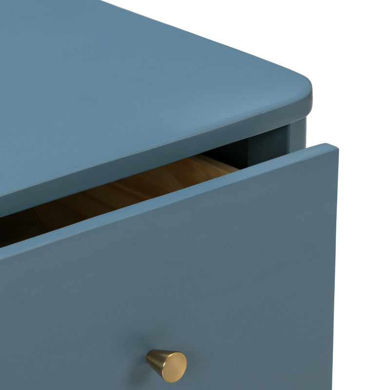 Matte blue wooden nightstand drawer with brass cone knob, close-up of slightly open modern dresser detail