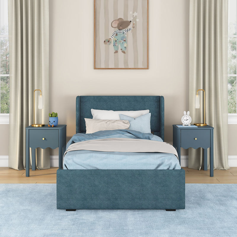 Modern navy blue upholstered twin bed with light blue bedding, matching blue nightstands and gold bedside lamps in a cozy kids bedroom with mouse wall art and pale blue rug