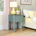 Teal wooden nightstand with scalloped drawer, yellow ceramic lamp, smiling succulent planter, and cozy beige upholstered bed in pastel bedroom décor