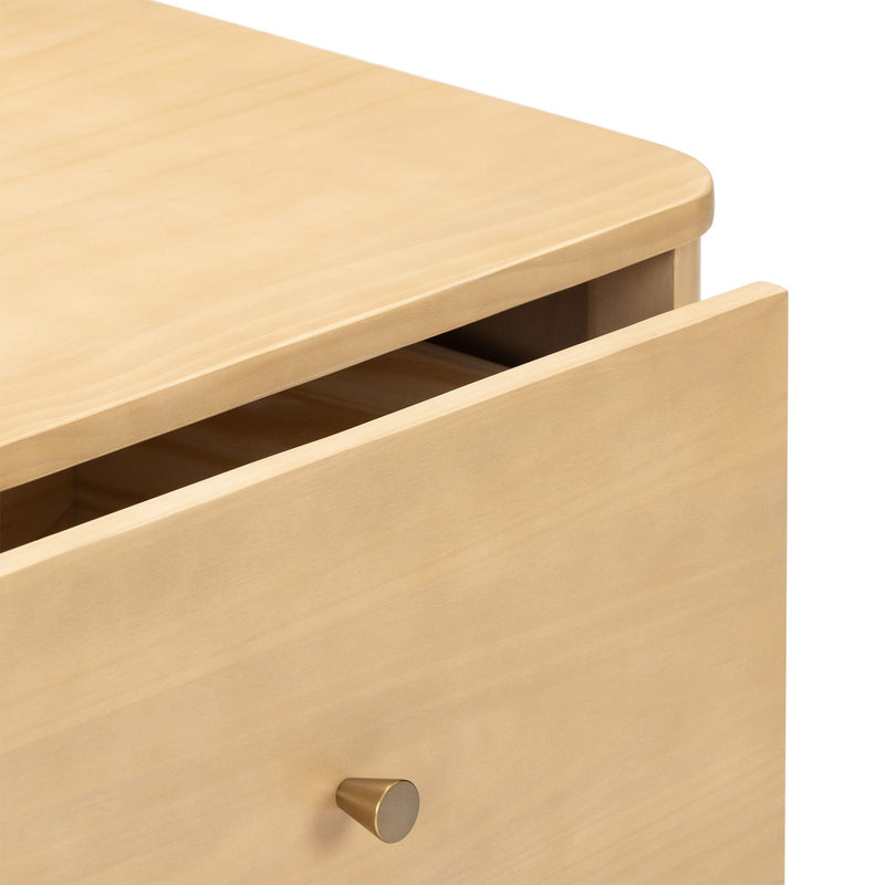 Minimalist light wood dresser drawer with rounded top edge and brass cone knob — modern maple nightstand detail for bedroom furniture