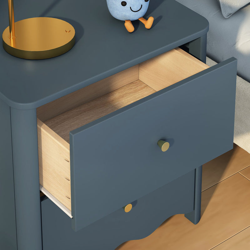 Blue modern bedside table (nightstand) with open drawer revealing light wood interior, gold round knobs, brass lamp and plush toy on hardwood floor