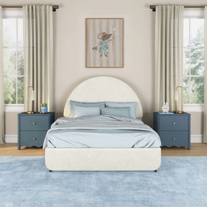 Modern children's bedroom with cream round upholstered headboard, light blue bedding, navy nightstands, gold lamps, beige curtains and mouse wall art