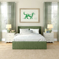Bright modern bedroom with green upholstered bed, gray-striped bedding, green curtains, white nightstands, bedside lamps and framed dog watercolor art